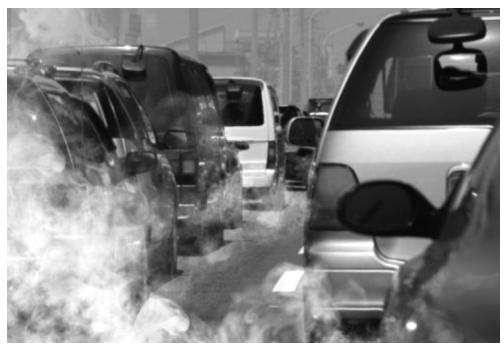 Fotografía de tráfico urbano con emisiones de gases de escape.